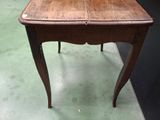 a small wooden table with a drawer on top of it