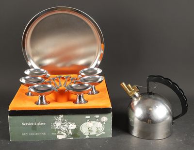 a silver tea kettle and a silver tea kettle on a table