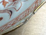 a close up of a plate with a dragon on it