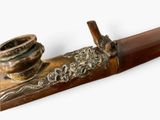 a pipe that is sitting on top of a wooden stick