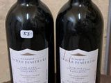 deux bouteilles de vin posées sur une table l'une à côté de l'autre