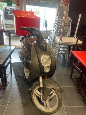 a motor scooter that is parked in a restaurant