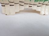 a picture of a ceramic elephant figurine with green and white stripes