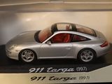 a silver toy car in a box on a table