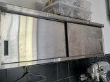 a kitchen with a sink and a mirror on the wall