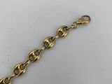 a close up of a gold chain bracelet on a white surface