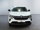 the front view of a white suv parked in a showroom