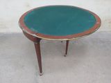 an image of a small table with a green top on a concrete floor