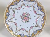an image of a plate with flowers on it on a stand