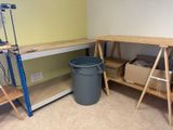 a picture of a work area with a work bench and a trash can