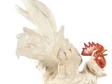 a figurine of a rooster on a white background