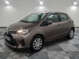 the toyota yaris is parked on a checkered tile floor