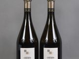 two bottles of wine sitting on top of a table next to each other