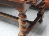 a wooden table with a wooden top and a wooden base