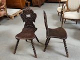 two chairs that are sitting next to each other in a room
