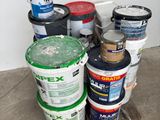 several buckets of paint sitting on the floor next to each other