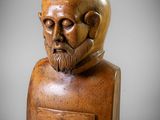 a wooden bust of a man with a beard and mustache