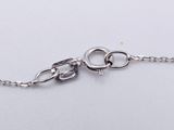 a close up of a silver chain with a heart on it