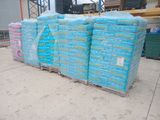 a large pile of blue plastic bags on a pallet