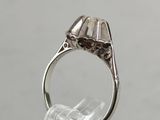 a close up of a silver ring with a diamond in it