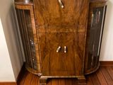an image of a living room with wood floors and a wooden cabinet