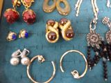 many different types of jewelry on a blue mat