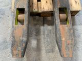 a wooden bench made out of pallets on a cement floor