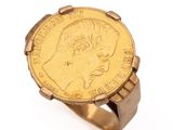 an image of a gold coin ring with a woman ' s face on it