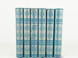 a set of five blue books sitting on top of each other