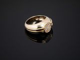 a close up of a gold ring with diamonds on a black surface