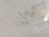 a close up of a silver plate with a name on it
