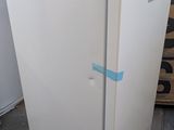 a white refrigerator with a blue tape on the door