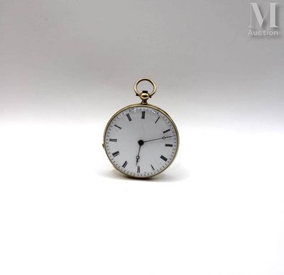 a small gold pocket watch on a white surface