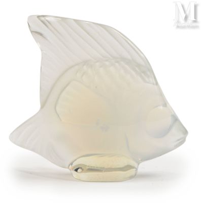 a glass figurine of a fish on a white background
