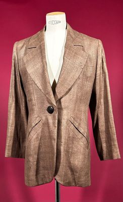 brown blazer on a mannequin stand against a red background