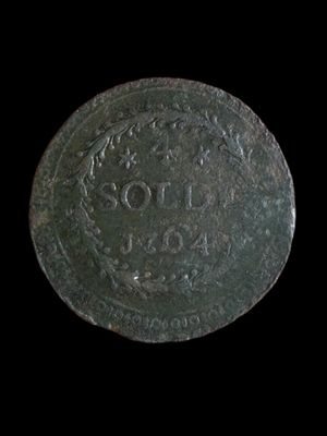 a close up of a coin on a black background