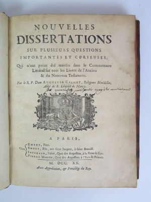 an old book with writing on it sitting on a table