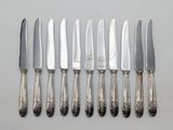 five knives and a knife holder on a table