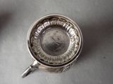 a silver cup that is sitting on a table
