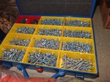 many different types of screws and nuts in a box
