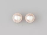 a pair of pearl earrings on a gray background