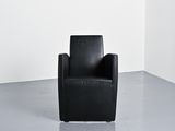 an image of a black chair in a white room