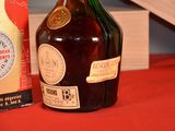 a bottle of liquor sitting next to a box on a table