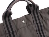a close up of a gray bag with black stripes on it