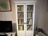 a chair and a desk in a room with a bookcase