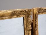 pair of antique gold framed mirrors with ornate carvings on the sides