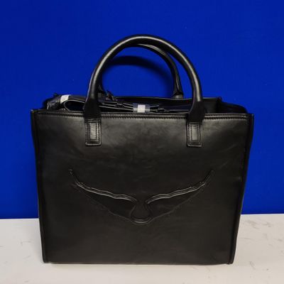 a black leather handbag with a winged design on the front