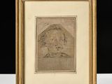 un dessin représentant le visage d'un homme, encadré dans un cadre doré