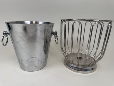 two metal buckets sitting next to each other on a table