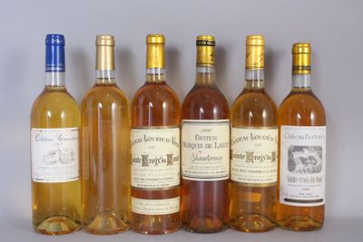 six bottles of wine are lined up in a row on a table